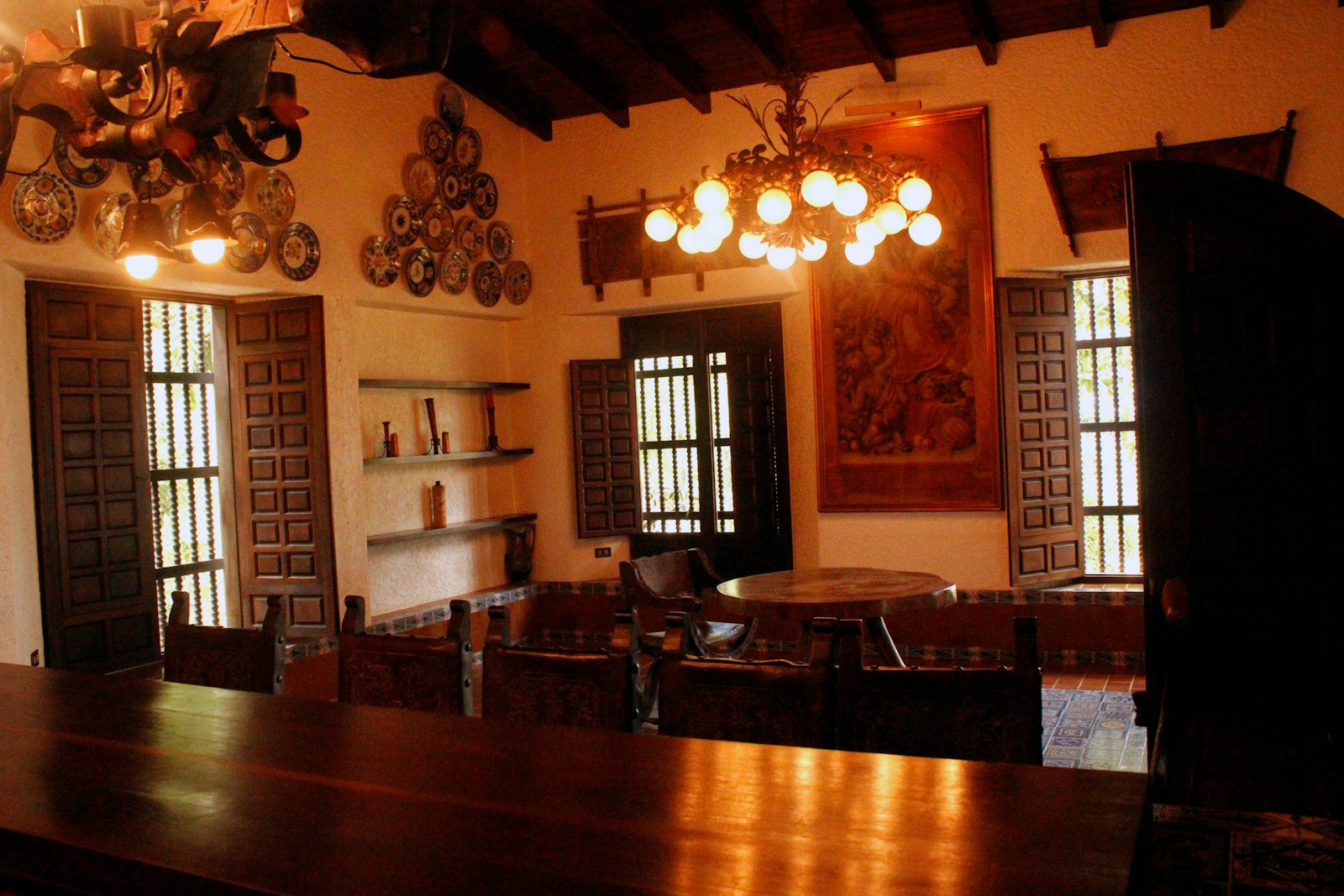 a dining room with a wooden table and chandelier